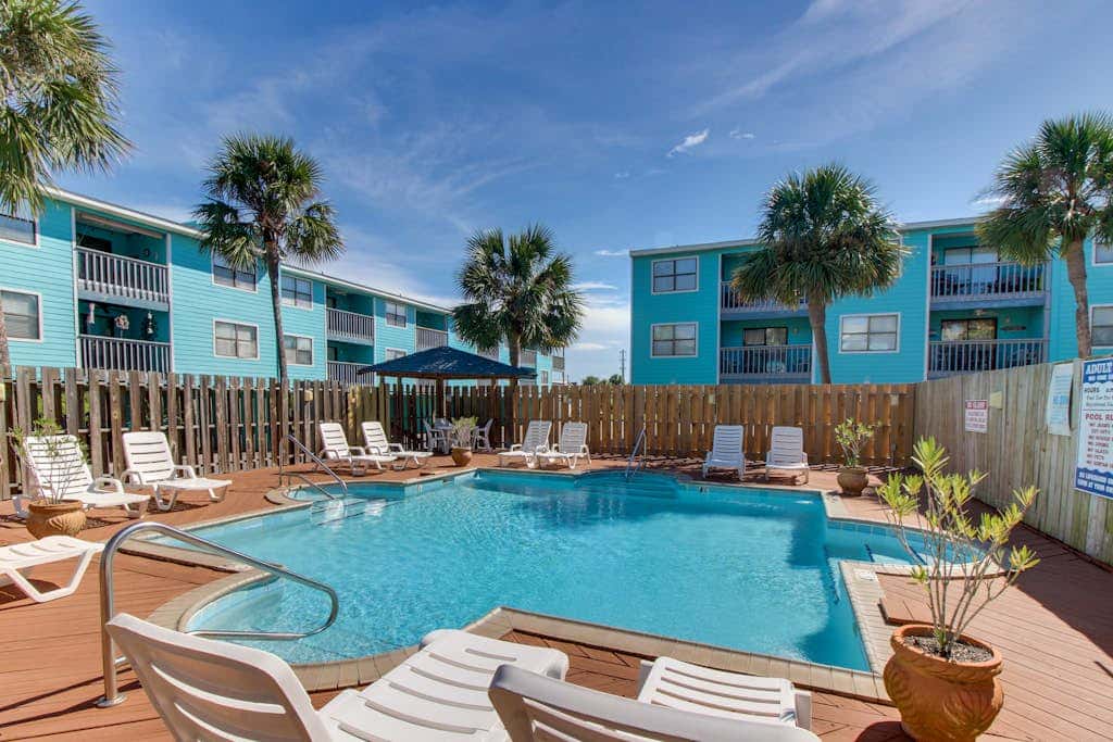 Waterfront condo with a furnished balcony, peek-a-boo Gulf views, & shared pools
