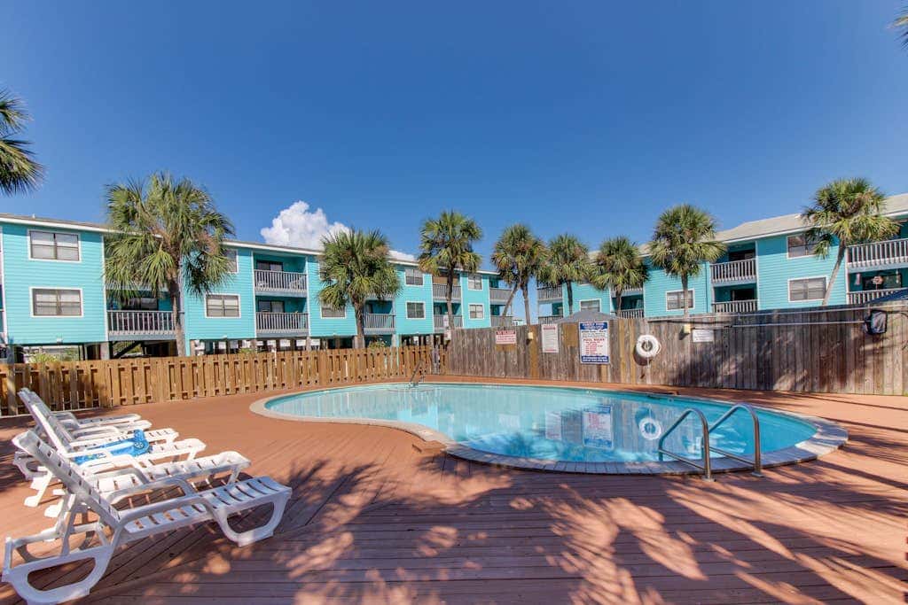 Waterfront condo with a furnished balcony, peek-a-boo Gulf views, & shared pools