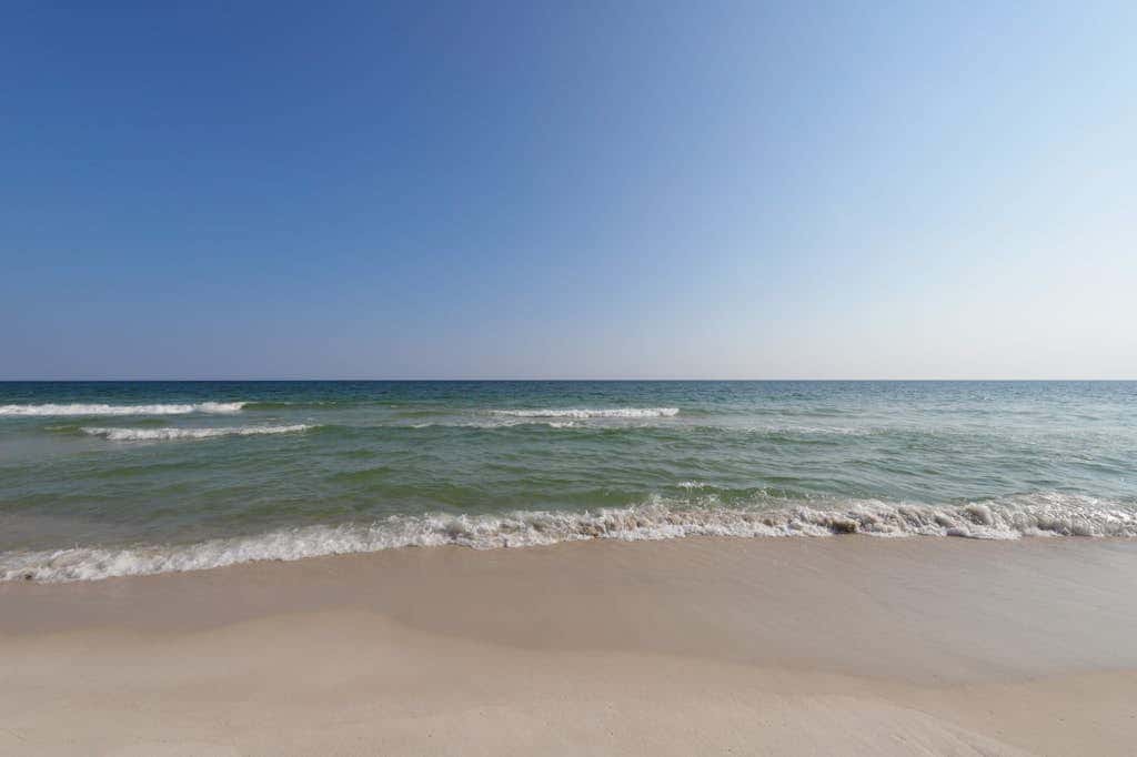 Waterfront condo with a furnished balcony, peek-a-boo Gulf views, & shared pools