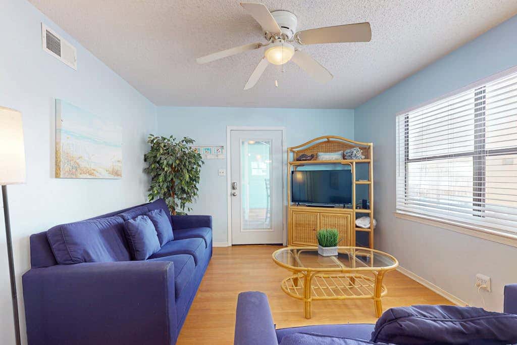 Waterfront condo with a furnished balcony, peek-a-boo Gulf views, & shared pools