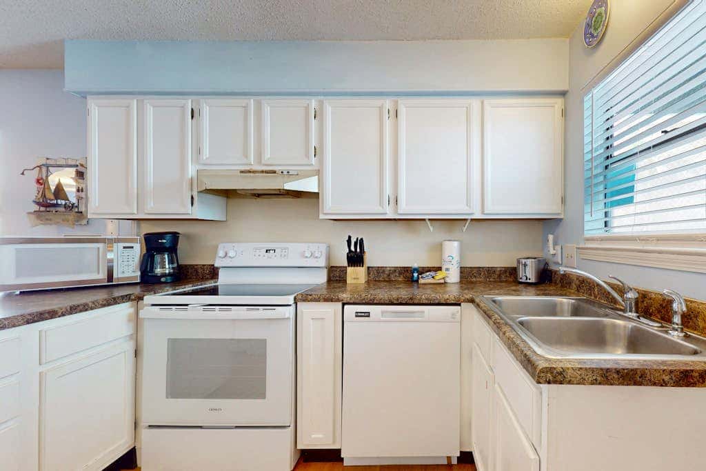 Waterfront condo with a furnished balcony, peek-a-boo Gulf views, & shared pools