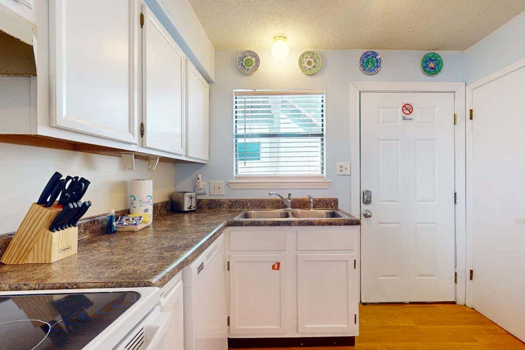 Waterfront condo with a furnished balcony, peek-a-boo Gulf views, & shared pools
