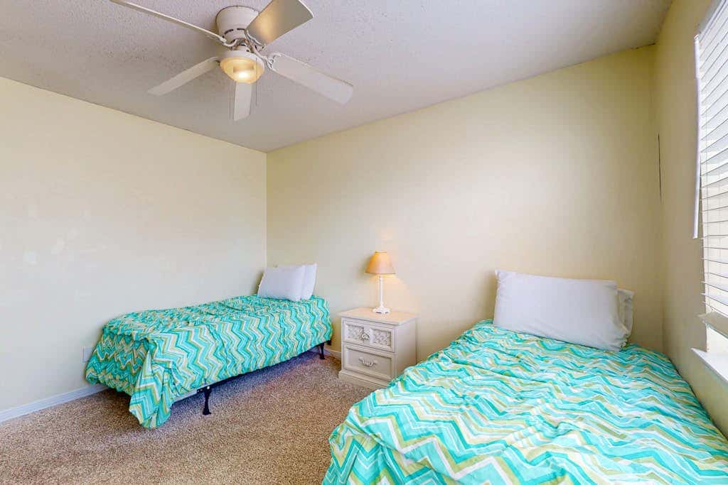 Waterfront condo with a furnished balcony, peek-a-boo Gulf views, & shared pools