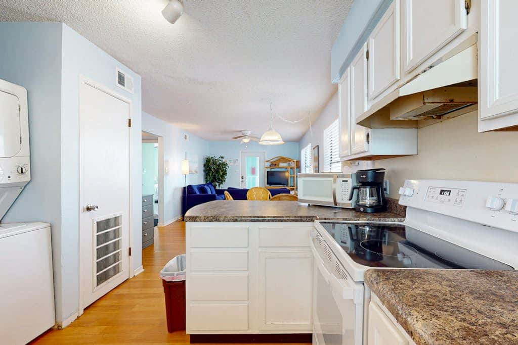 Waterfront condo with a furnished balcony, peek-a-boo Gulf views, & shared pools