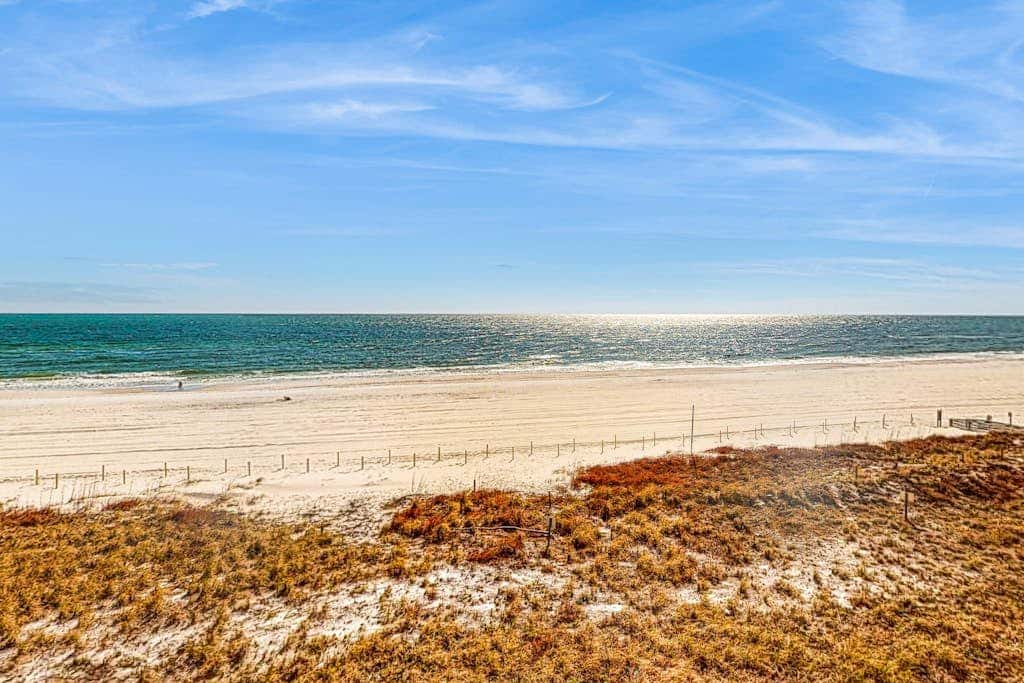 Beachfront resort condo with shared pool, tennis court, free WiFi, central AC