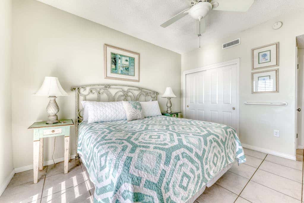 Waterfront corner condo with shared pools, wrap-around balcony, & tennis courts