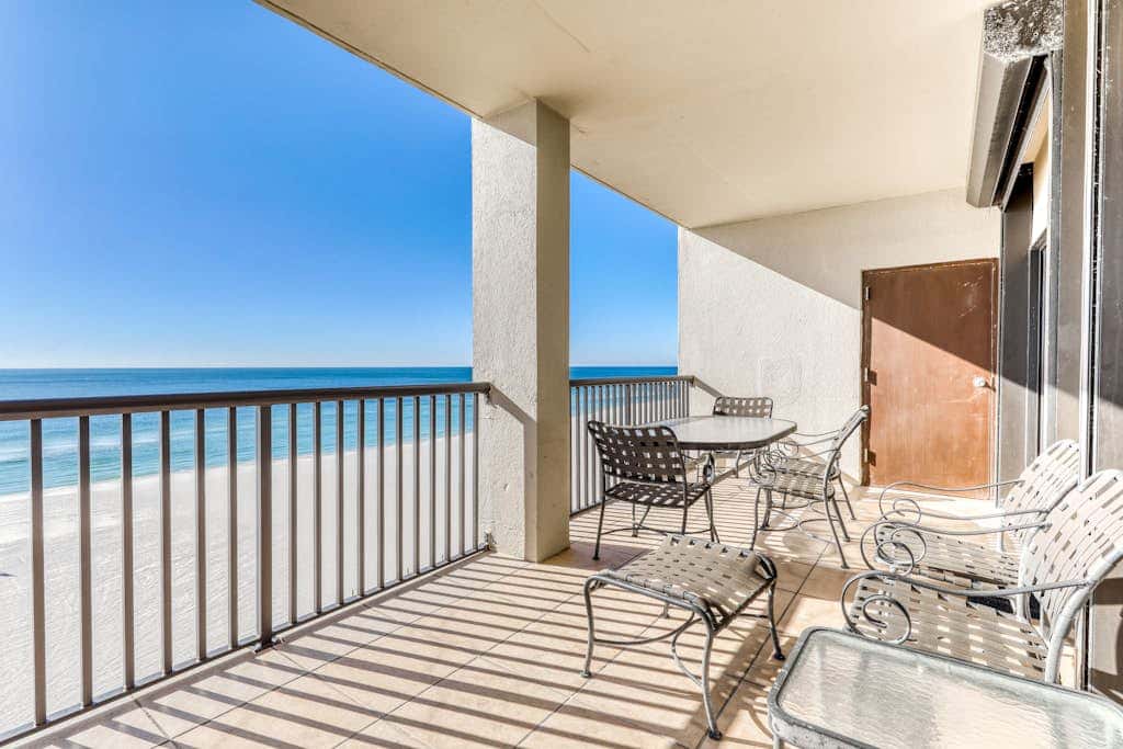 Waterfront corner condo with shared pools, wrap-around balcony, & tennis courts