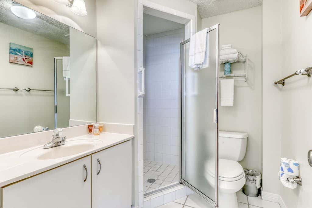 Waterfront corner condo with shared pools, wrap-around balcony, & tennis courts