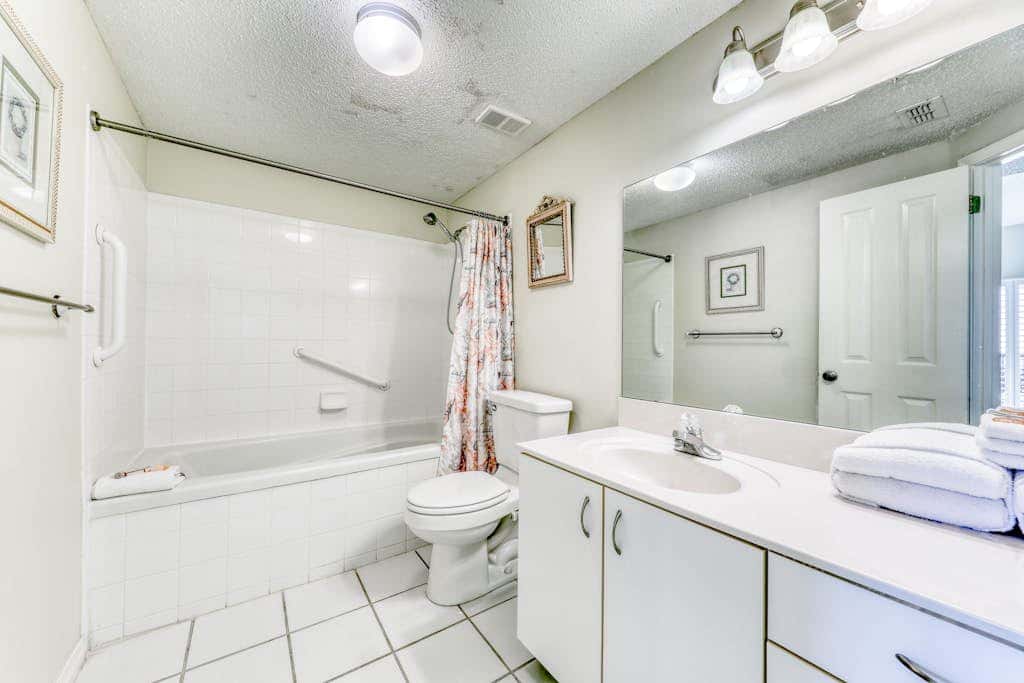 Waterfront corner condo with shared pools, wrap-around balcony, & tennis courts