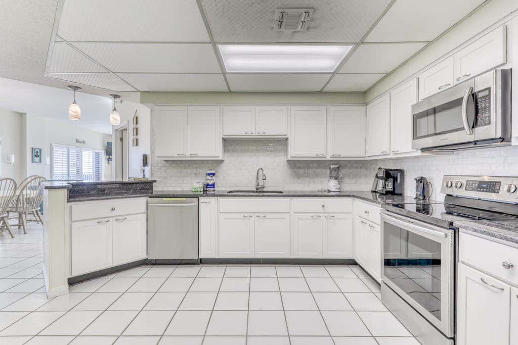 Waterfront corner condo with shared pools, wrap-around balcony, & tennis courts