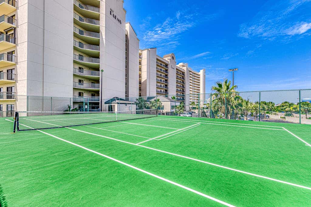 Waterfront corner condo with shared pools, wrap-around balcony, & tennis courts