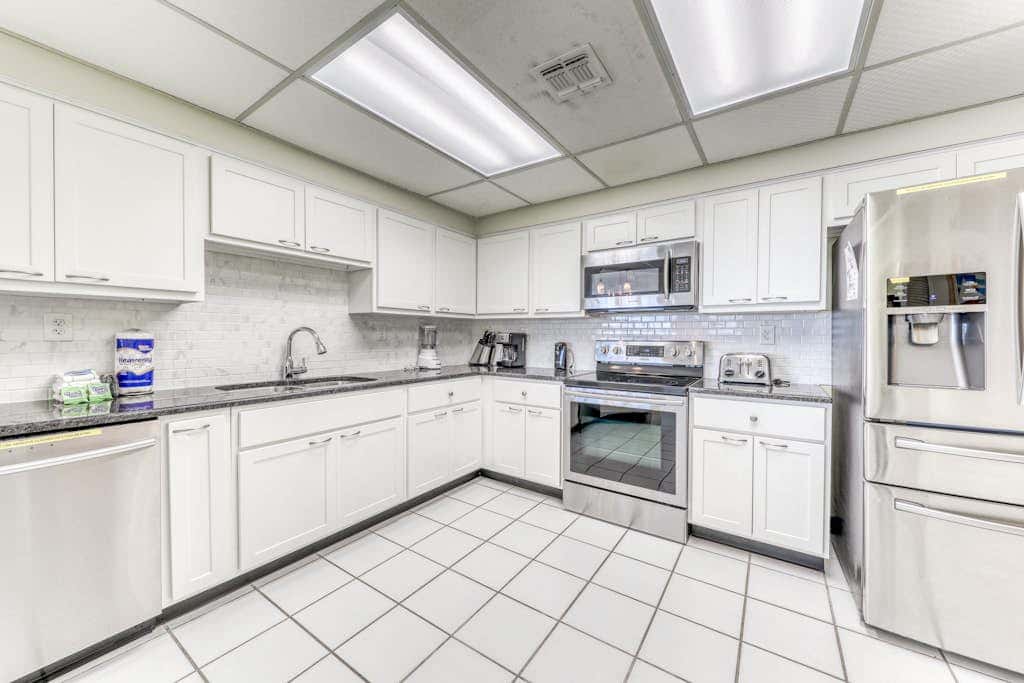 Waterfront corner condo with shared pools, wrap-around balcony, & tennis courts