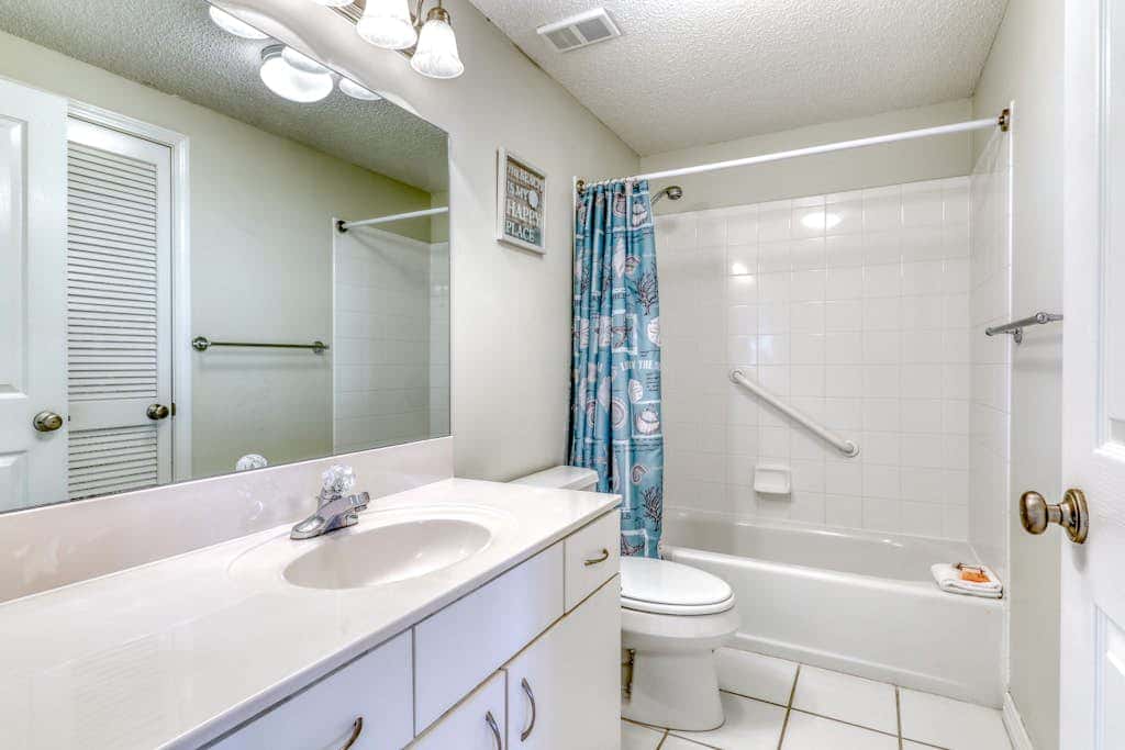 Waterfront corner condo with shared pools, wrap-around balcony, & tennis courts