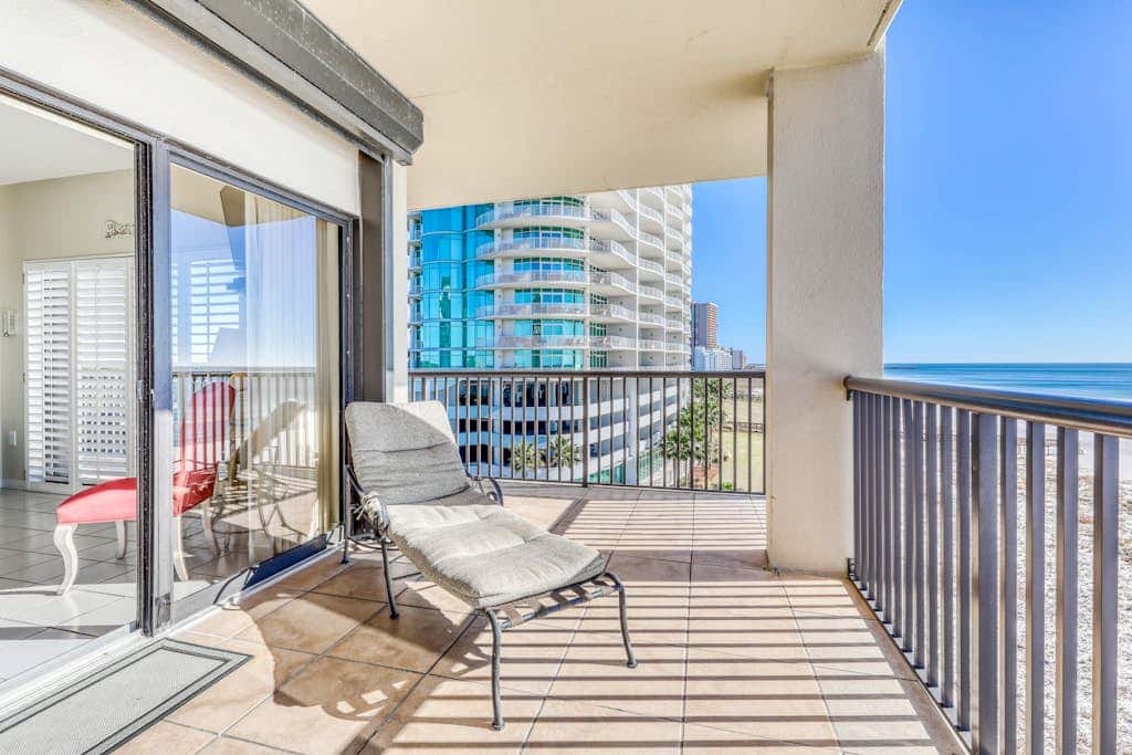 Waterfront corner condo with shared pools, wrap-around balcony, & tennis courts