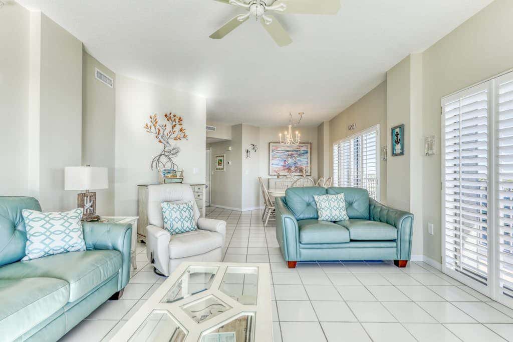 Waterfront corner condo with shared pools, wrap-around balcony, & tennis courts