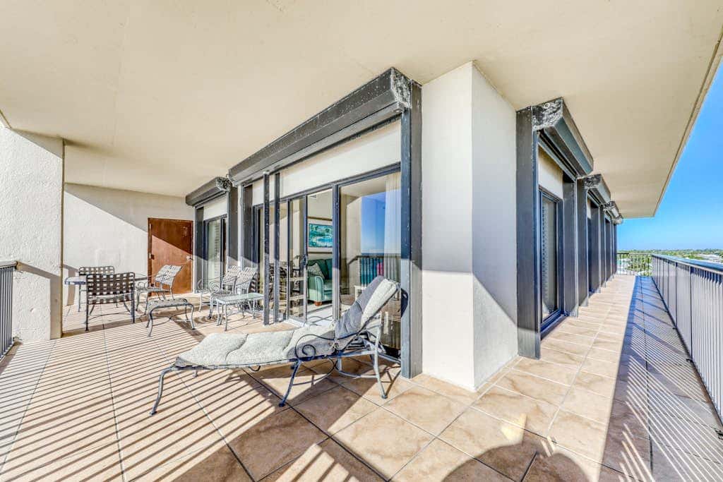 Waterfront corner condo with shared pools, wrap-around balcony, & tennis courts