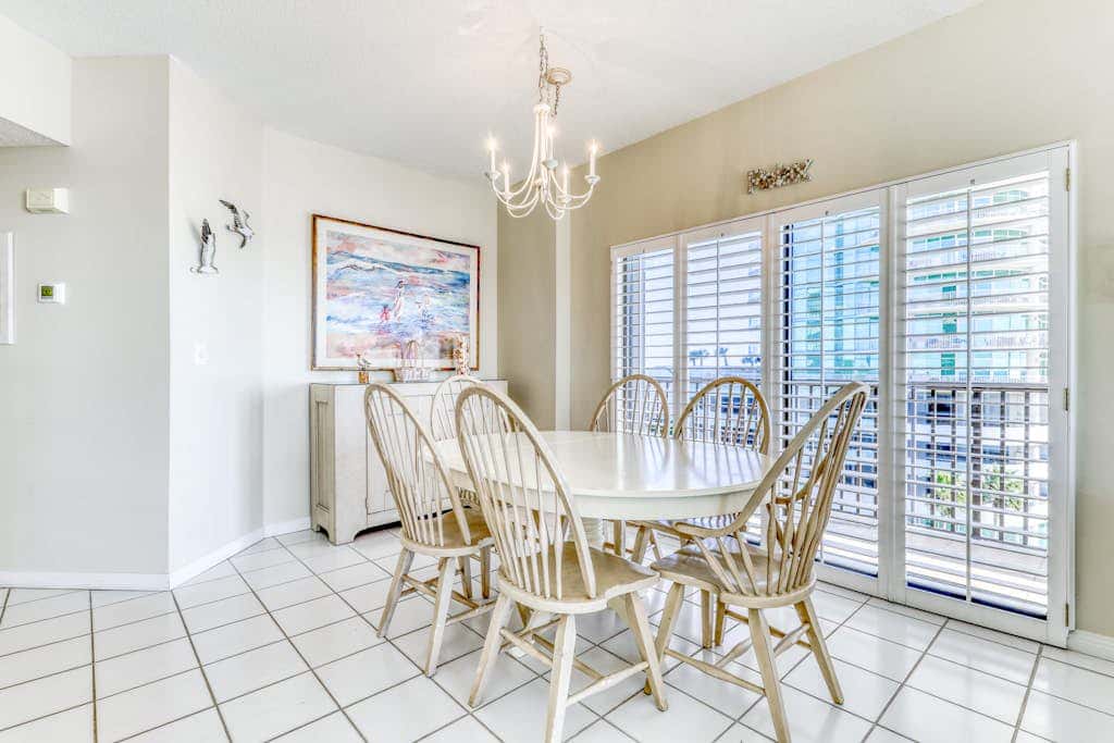 Waterfront corner condo with shared pools, wrap-around balcony, & tennis courts