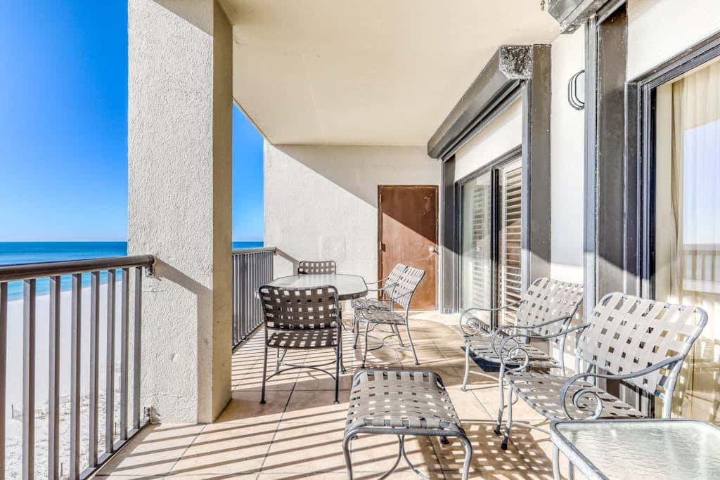 Waterfront corner condo with shared pools, wrap-around balcony, & tennis courts