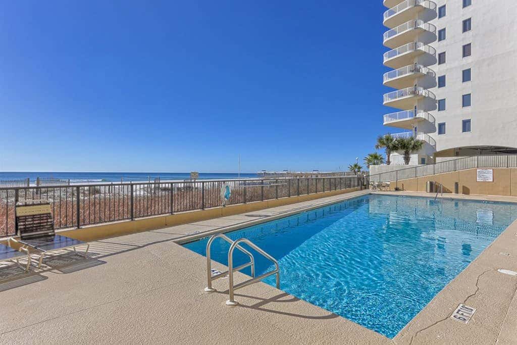 Beachfront condo with shared outdoor pool, heated indoor pool, sauna, & grill area