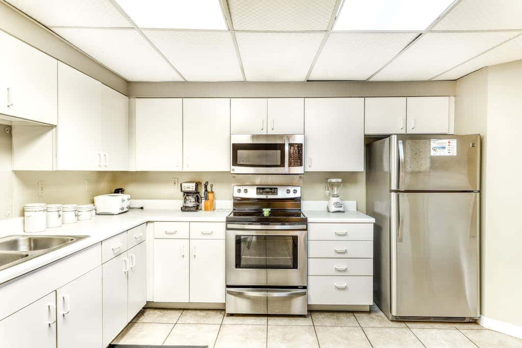 Beachfront condo with shared outdoor pool, heated indoor pool, sauna, & grill area