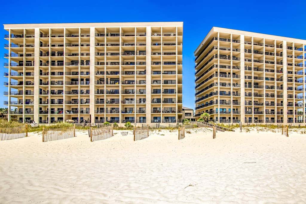 Beachfront condo with shared outdoor pool, heated indoor pool, sauna, & grill area