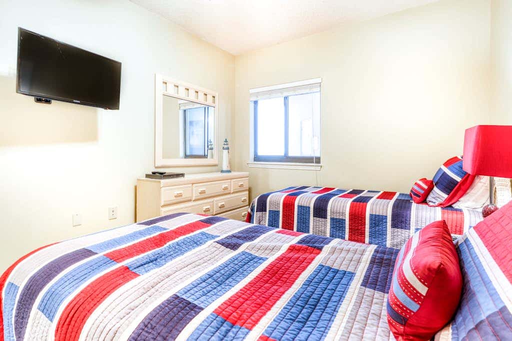 Beachfront condo with shared outdoor pool, heated indoor pool, sauna, & grill area