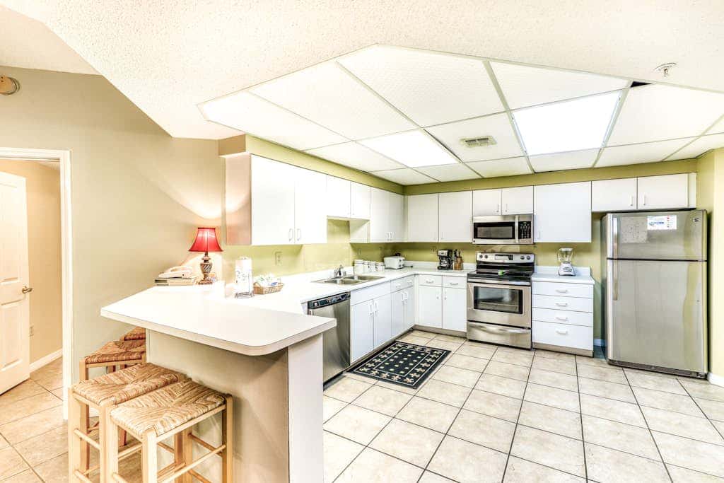 Beachfront condo with shared outdoor pool, heated indoor pool, sauna, & grill area