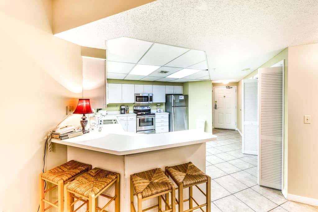 Beachfront condo with shared outdoor pool, heated indoor pool, sauna, & grill area