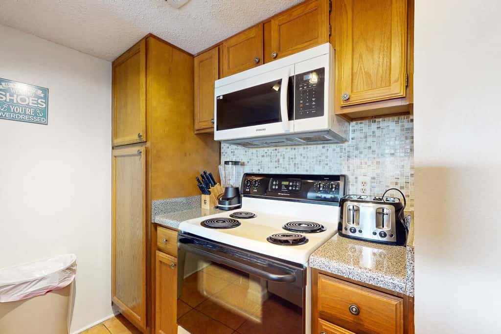 Gulf view condo with a full kitchen, private balcony, shared pools, & tennis court