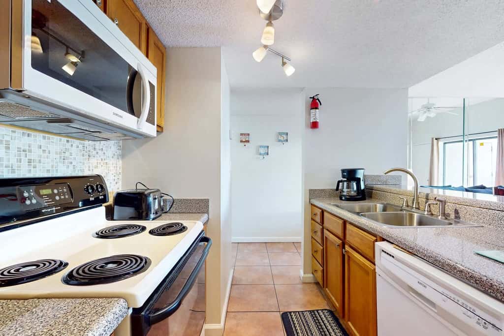 Gulf view condo with a full kitchen, private balcony, shared pools, & tennis court