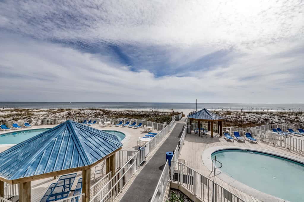 Gulf view condo with a full kitchen, private balcony, shared pools, & tennis court