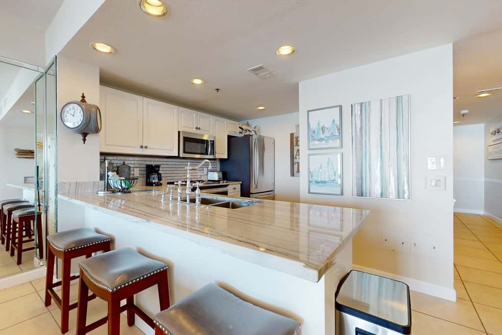 7th floor condo with ocean views, shared pool, central AC, and washer&dryer