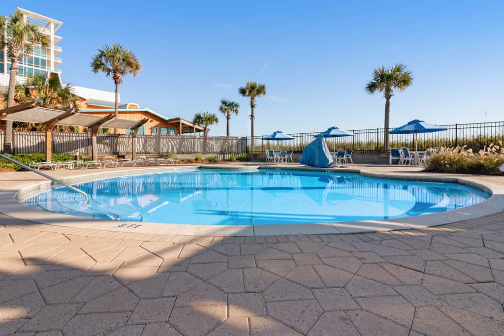 7th floor condo with ocean views, shared pool, central AC, and washer&dryer
