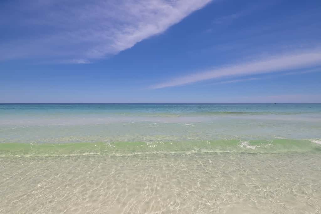 7th floor condo with ocean views, shared pool, central AC, and washer&dryer