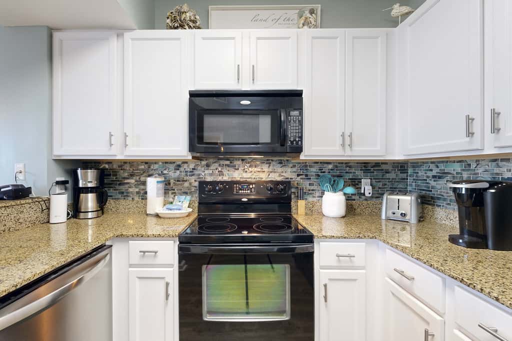 Water-view 11th-floor condo with hot tub, heated pool, tennis, sauna, gym, W/D