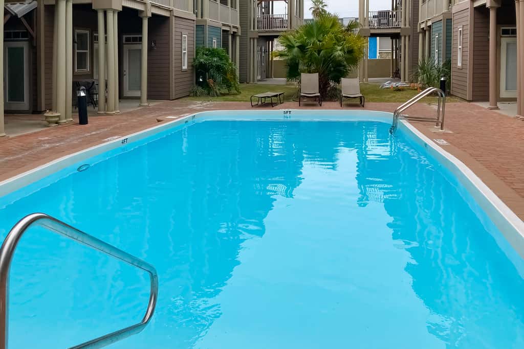 Dog-friendly home with balconies, foosball, pool access, & W&D - steps to beach