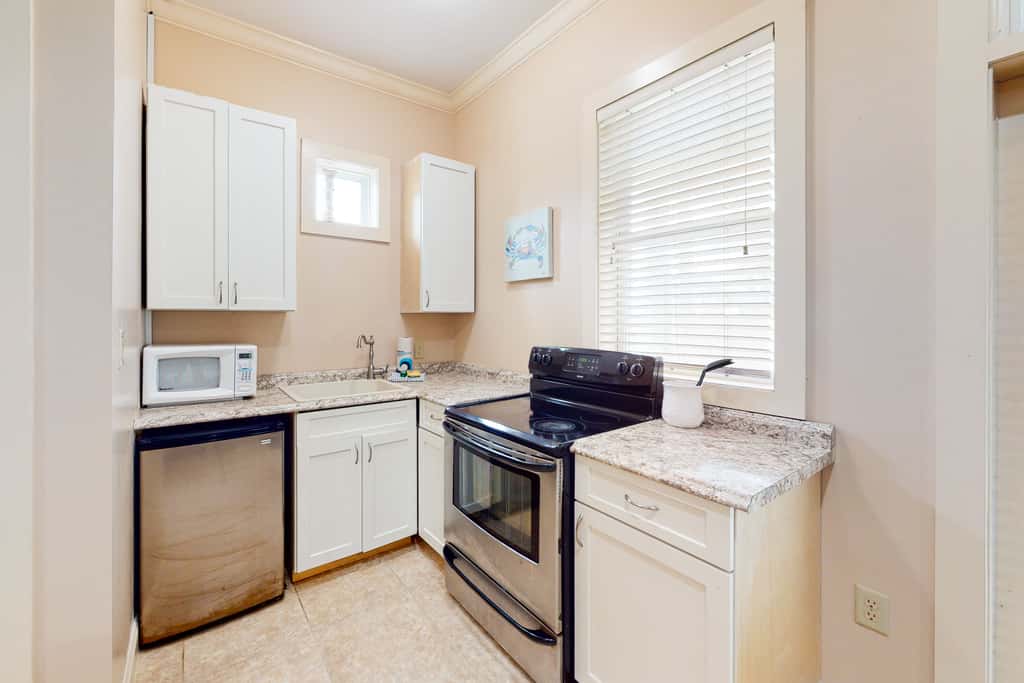 Dog-friendly home with balconies, foosball, pool access, & W&D - steps to beach