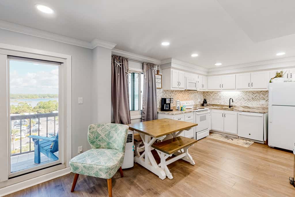 Beachfront condo in gated resort with pools, lake access, fast WiFi & patio