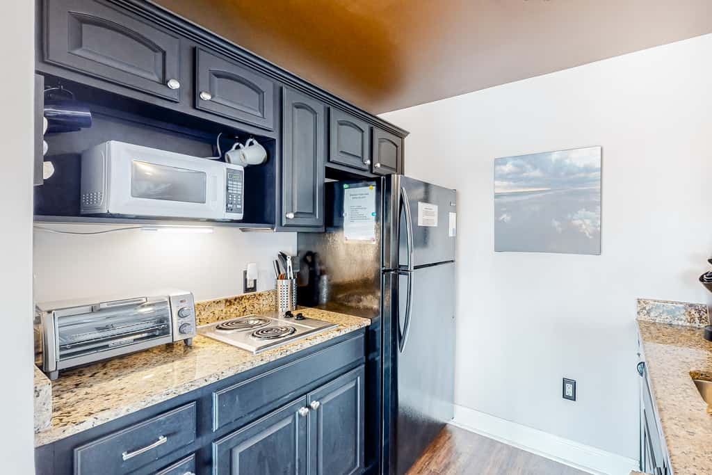 Water-view condo with on-site pool, hot tub, beachfront access, & sports courts