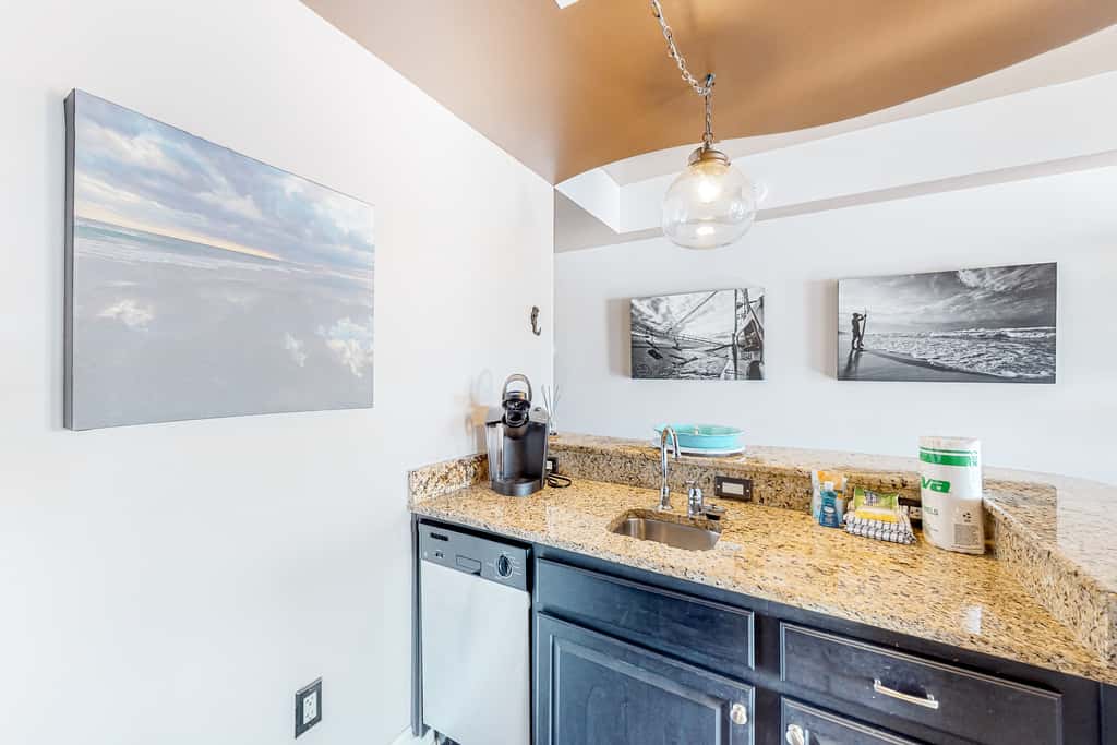 Water-view condo with on-site pool, hot tub, beachfront access, & sports courts