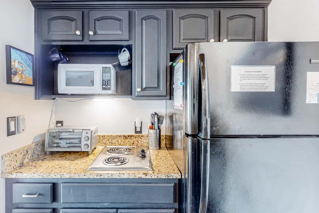 Water-view condo with on-site pool, hot tub, beachfront access, & sports courts