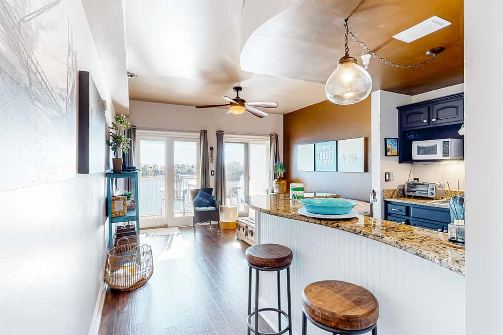 Water-view condo with on-site pool, hot tub, beachfront access, & sports courts