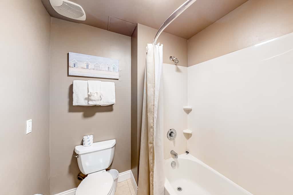 Water-view condo with on-site pool, hot tub, beachfront access, & sports courts