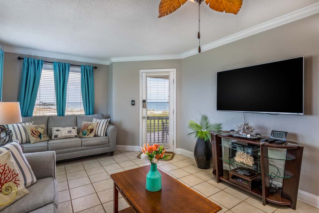 Condo with private balcony, pool, grills, central AC, & WD