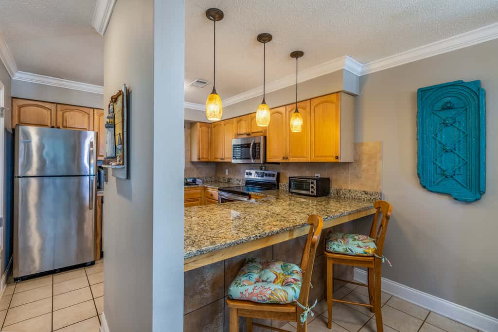 Condo with private balcony, pool, grills, central AC, & WD
