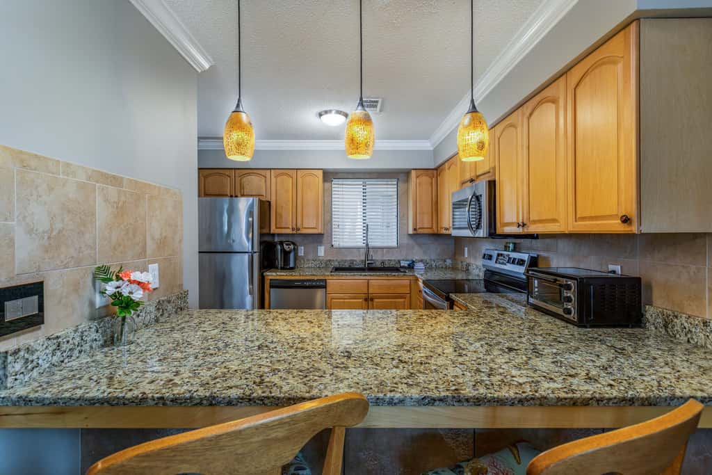 Condo with private balcony, pool, grills, central AC, & WD