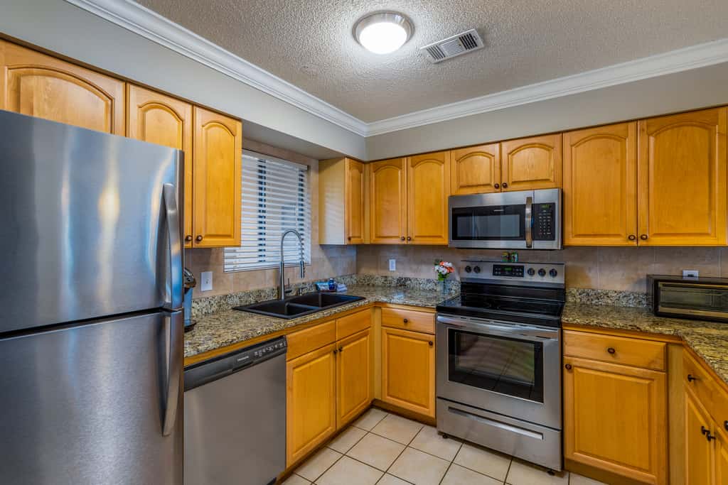 Condo with private balcony, pool, grills, central AC, & WD
