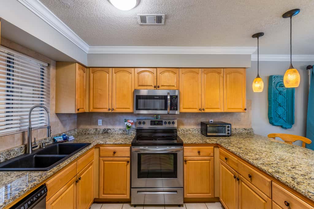 Condo with private balcony, pool, grills, central AC, & WD