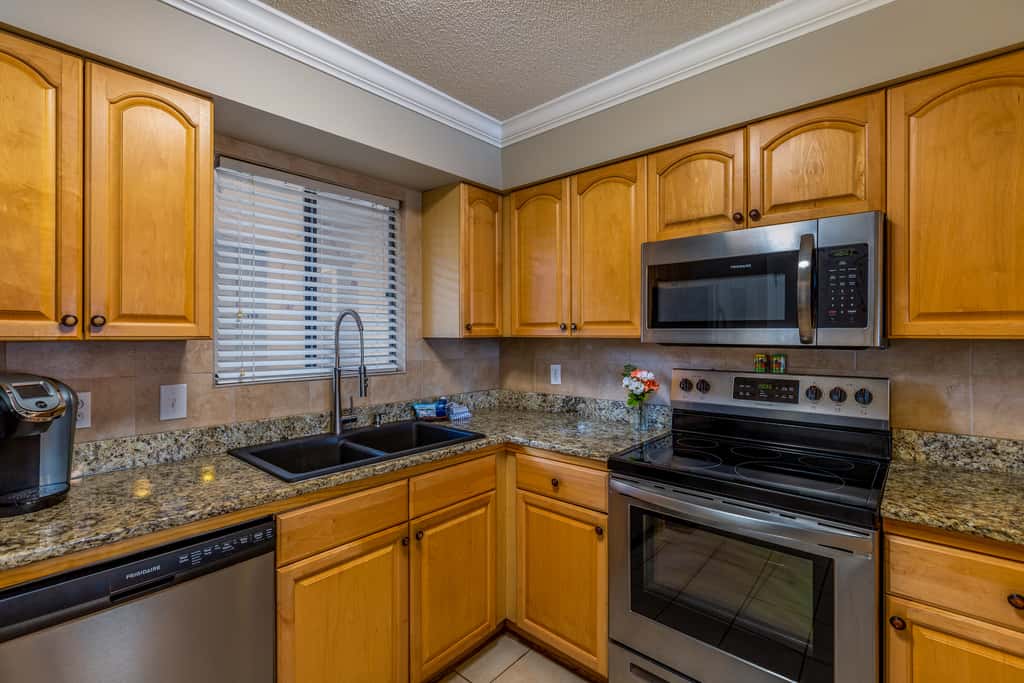 Condo with private balcony, pool, grills, central AC, & WD