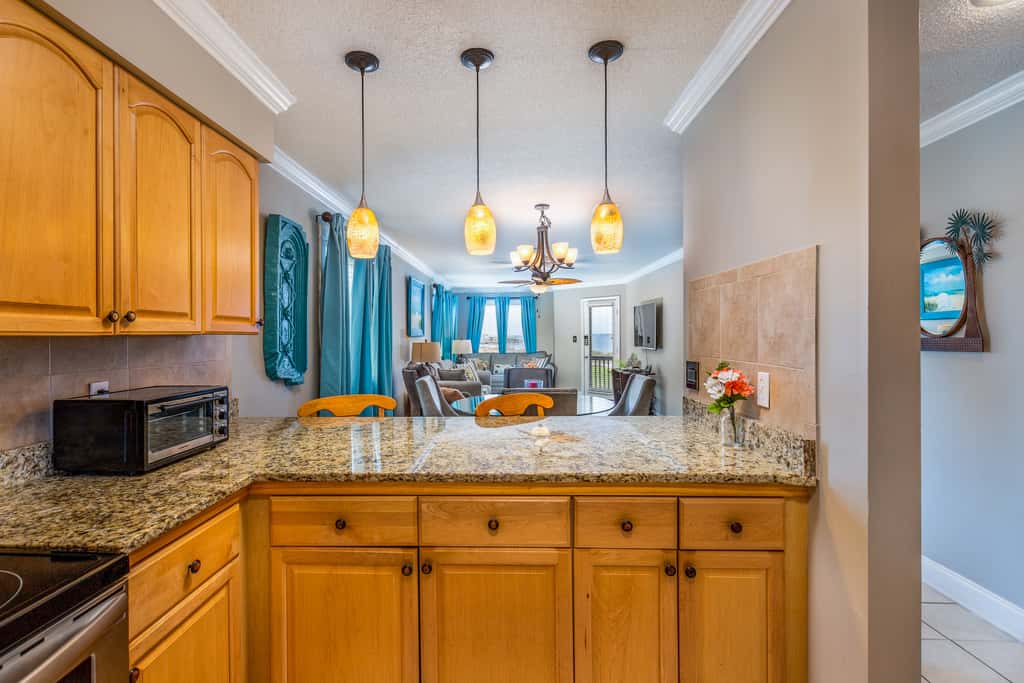 Condo with private balcony, pool, grills, central AC, & WD